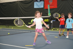 8 year old girl playing tennis at Rye Racquet Club Kids Program